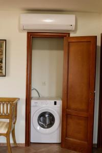 a washing machine in a room next to a door at Mountains Villa near Budva in Budva