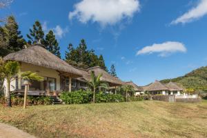 a row of cottages with thatched roofs at Ferney Nature Lodge in Mahébourg