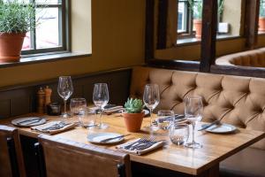 a table in a restaurant with wine glasses and napkins at The Cricketers Clavering in Clavering