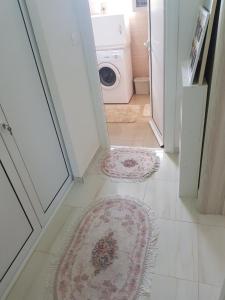 a hallway with a door open to a laundry room with rugs at Guest house Nina in Bar +8 photos