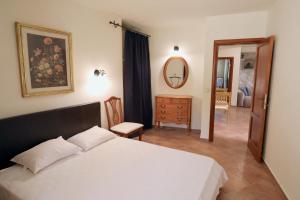 a bedroom with a bed and a dresser and a mirror at Mountains Villa near Budva in Budva +58 photos