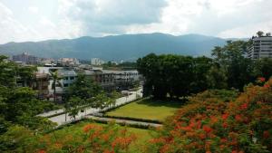 Blick auf eine Stadt mit Bergen im Hintergrund in der Unterkunft The Dome Residence in Chiang Mai