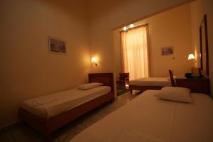 A bed or beds in a room at Lena Hotel