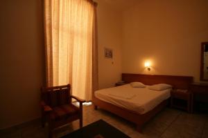 A bed or beds in a room at Lena Hotel