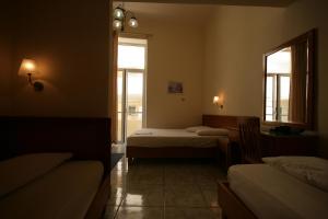 A bed or beds in a room at Lena Hotel