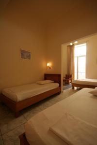 A bed or beds in a room at Lena Hotel