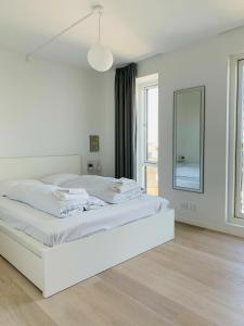 a white bedroom with a white bed and a window at ApartmentInCopenhagen Apartment 1453 in Copenhagen