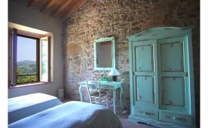 a bedroom with a bed and a table with a mirror at SacreTerre B&B e Agriturismo in Tizzano Val Parma