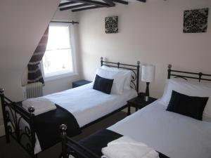 a bedroom with two beds and a window at The Old Town Bed and Breakfast in Hastings