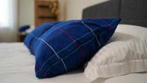 a blue pillow sitting on top of a bed at Apartment Aria in Verunić +21 photos