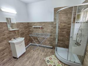 a bathroom with a shower and a sink at Let's do! Sunshine in Năvodari