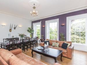 a living room with a couch and a table at 3 Berkeley Square Guesthouse in Bristol