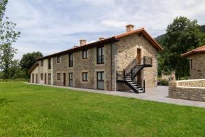an exterior view of a stone building with a staircase at Complejo Rural El Cerradón in Alceda