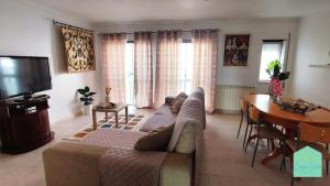 a living room with a couch and a table at Casa Lena - Sítio da Nazaré in Nazaré