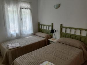 1 dormitorio con 2 camas y ventana en Apartamentos Vista, en Peñíscola