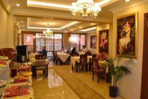 a restaurant with people sitting at tables in a room at Blue Istanbul Hotel in Istanbul