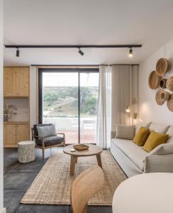 a living room with a couch and a table at Ericeira Prime Villas in Ericeira