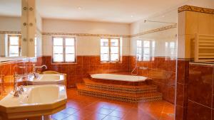 a bathroom with a tub and a sink at Landvilla Theresien-Gut, 20 - 25 Personen in Marktoberdorf +28 photos