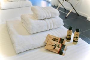 a bathroom with towels and two bottles of shampoo at Cetara Costa d'Amalfi Residence in Cetara