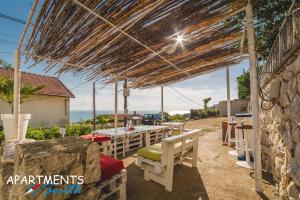 a patio with a table with a view of the ocean at Apartments South in Ulcinj