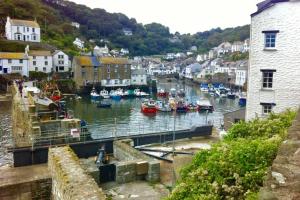 a harbor with boats in the water in a town at Large House in Looe, Near Beach and Bars with Great Views, Free Parking and Free Access to a Nearby Indoor Swimming Pool in Looe