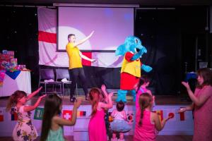 a group of children watching a man and an elephant on a stage at Large House in Looe, Near Beach and Bars with Great Views, Free Parking and Free Access to a Nearby Indoor Swimming Pool in Looe