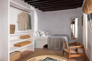 A bed or beds in a room at Eole Tarifa Rooms