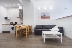 a living room with a couch and a table at Exclusivos Lofts en Plaza del Ayuntamiento in Valencia