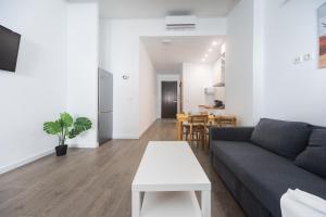 a living room with a couch and a table at Exclusivos Lofts en Plaza del Ayuntamiento in Valencia