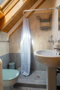 a bathroom with a sink and a toilet at Una Bella Mansarda in Argostoli