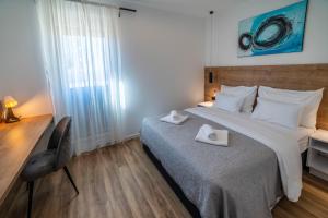 Postel nebo postele na pokoji v ubytování PINNA RESIDENCE - SV. JEROLIM + 36 fotografií