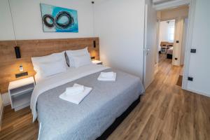 Postel nebo postele na pokoji v ubytování PINNA RESIDENCE - SV. JEROLIM