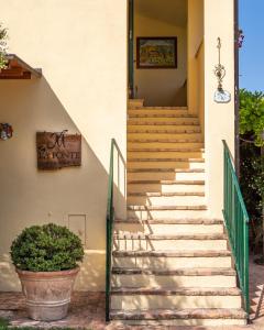 a staircase leading up to a house with a plant at Agriturismo La Fonte in Bevagna