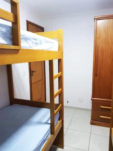 a room with three bunk beds in a room at Duplex com churrasqueira e Wi-Fi no Rio de Janeiro in Rio de Janeiro