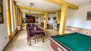 a dining room with a pool table in a room at Guest House Au Nature in Golyama Zhelyazna