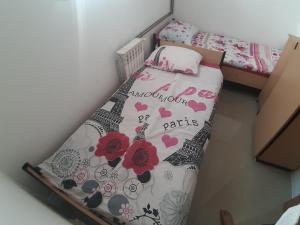a small bedroom with a bed in a room at Ris in Foča
