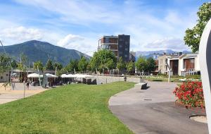 a park in a city with a building and mountains at APARTAMENTO PIRINEO DE HUESCA, JACA, FORMIGAL, PANTICOSA in Sabiñánigo