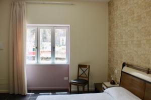 a bedroom with a bed and a window at Cetara Costa d'Amalfi Residence in Cetara