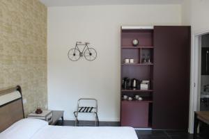 a bedroom with a bed and a bike on the wall at Cetara Costa d'Amalfi Residence in Cetara