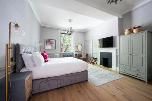 a bedroom with a large bed and a fireplace at Eight in Bath