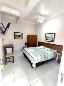 a bedroom with a bed and a chair at Colinas Hotel in Machado +18 photos