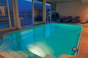 a swimming pool in a house with a view at Tresa Bay Hotel - Lake Lugano in Ponte Tresa