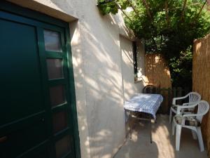 a door of a house with a table and chairs at Apartment Tomato in Pula