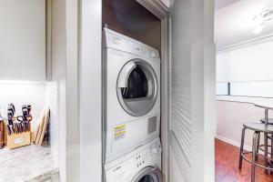 a laundry room with a washer and dryer at Encinal Condominiums in Austin