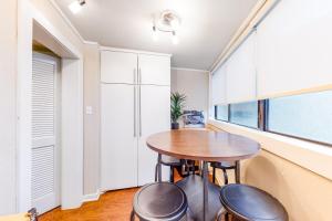 a kitchen with a table and two stools at Encinal Condominiums in Austin