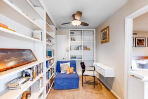 a home office with a blue chair and a desk at Encinal Condominiums in Austin