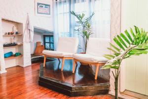 two white chairs and a table in a room at Passagem Concept Hotel e Spa in Cabo Frio +85 photos