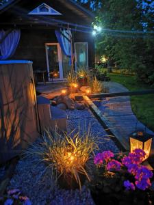 a backyard garden at night with lights and flowers at Green Garden house in Jūrmala