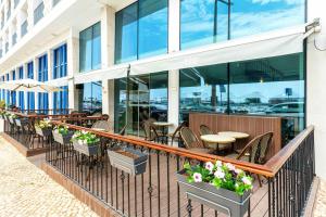 a balcony of a restaurant with tables and chairs at AP Eva Senses in Faro