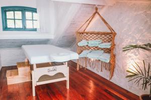 a room with a hanging rack of folded towels at Passagem Concept Hotel e Spa in Cabo Frio